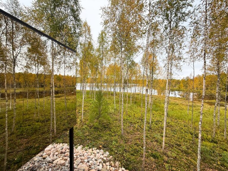 Summer day and the glass cabin by the lake. Silver Birch Resort in Rovaniemi, Lapland